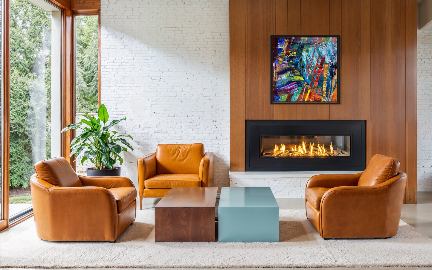 Modern living room with leather chairs, a coffee table, and a fireplace.
