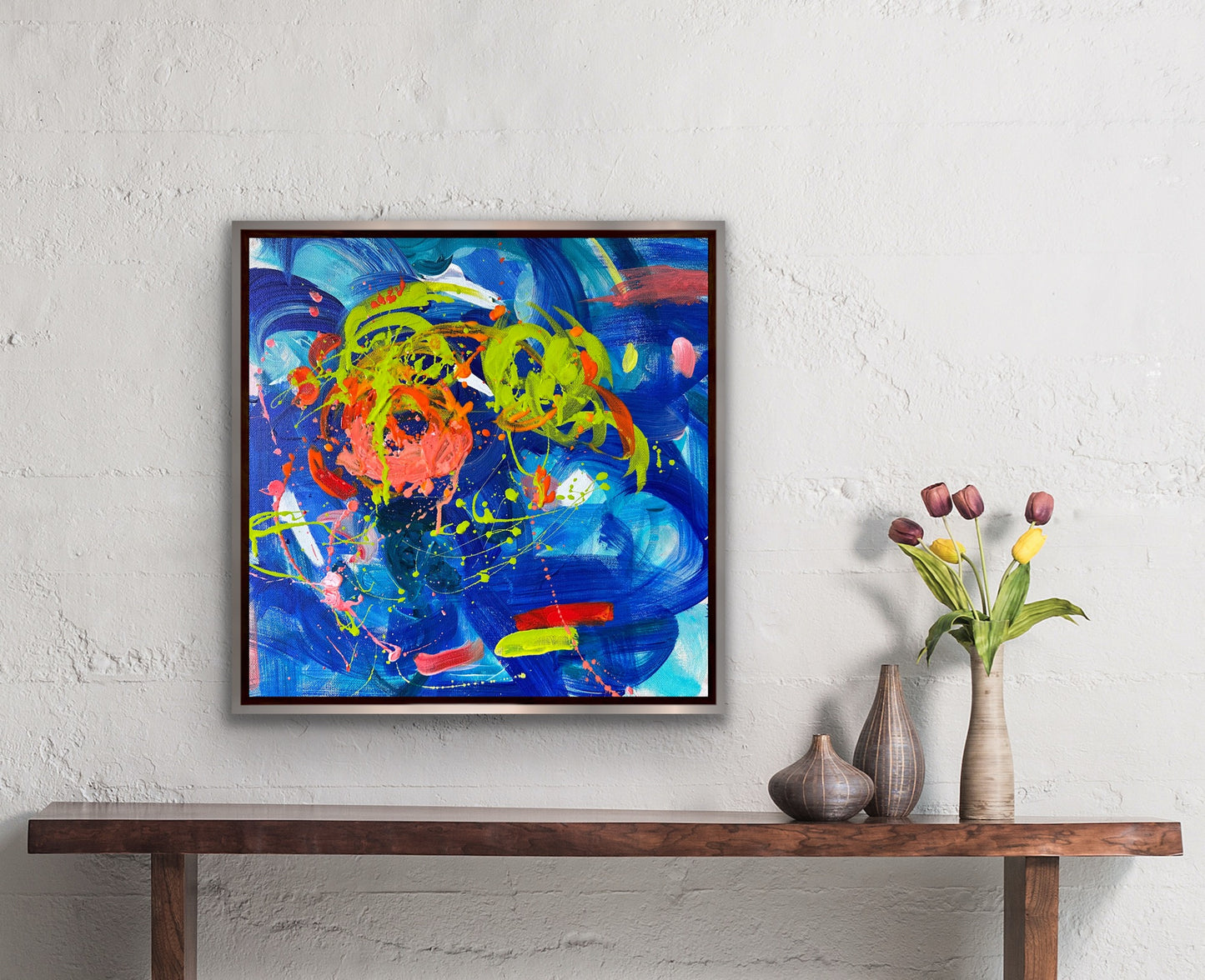 This vibrant 16” x 16” abstract acrylic painting bursts with playful energy through its dynamic blend of blues and oranges. Its lively composition invites you to explore a world of color and movement, perfect for adding a cheerful and artistic touch to any space.