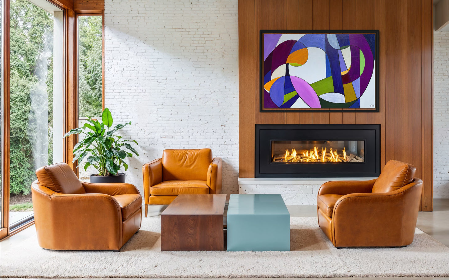 Modern living room with leather chairs, a coffee table, and a colorful abstract painting above a fireplace.