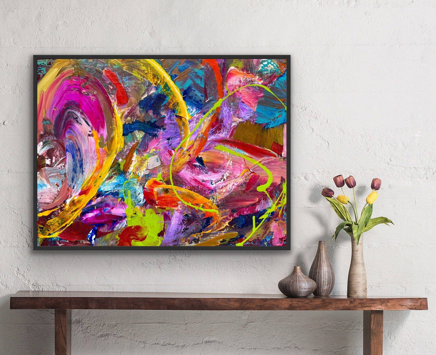 Atomic original acrylic painting by Maria-Victoria Checa displayed in black frame above wood console, bold colorful wall art