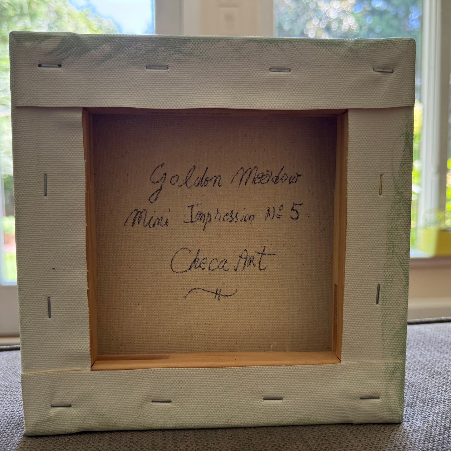 golden-meadow-miniature-impressions-no5-back-of-canvas-checa-art.jpg
Alt text: Back of canvas showing handwritten title Golden Meadow, Mini Impression No. 5, original artwork by Maria-Victoria Checa, Checa Art