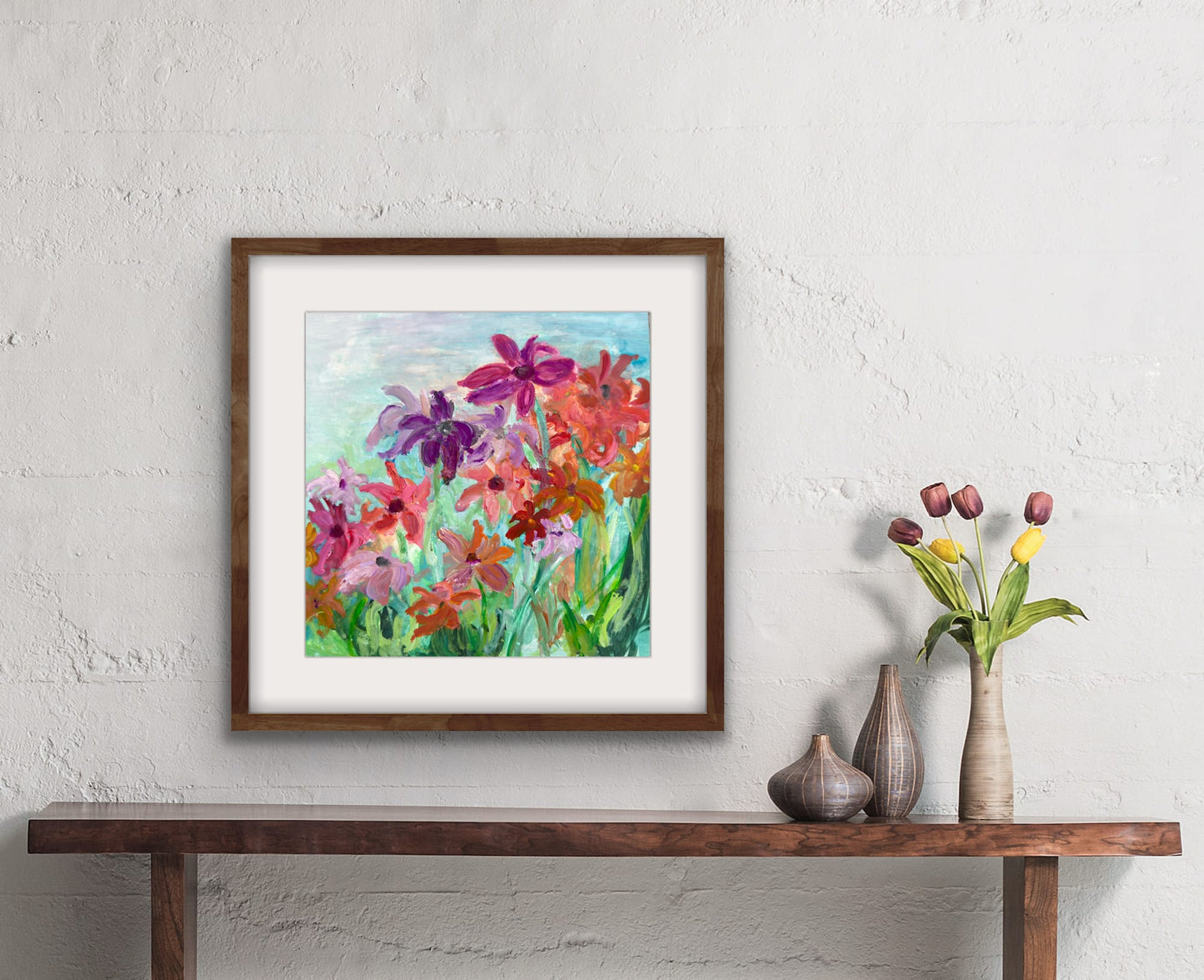 "Joie de Vivre floral watercolor painting by Washington, DC artist Maria-Victoria Checa in a walnut frame above a console table with tulips"