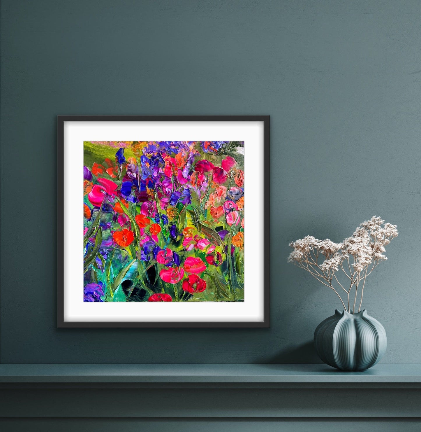 Pink Flowers framed floral art print styled on a blue wall, by artist Maria-Victoria Checa.