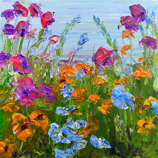 Modern impressionist acrylic painting of wild flowers by the sea in tones purple, pink and light blue.