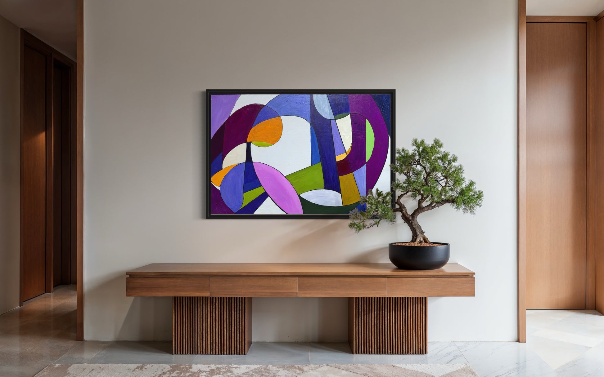 Modern interior with a colorful abstract painting on the wall above a wooden console table.