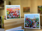 Prairie and Wildflower Meadow Greeting Cards — two 5×5 impressionist landscape cards displayed on a wood box, by Washington DC artist Maria-Victoria Checa