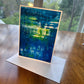 Deep blue and green abstract painting greeting card with luminous yellow reflections — 5x7 art card by Maria-Victoria Checa