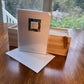 Checa Art abstract greeting card set back of package with branded label reading Bleu and mvchecaart.com next to open wood gift box