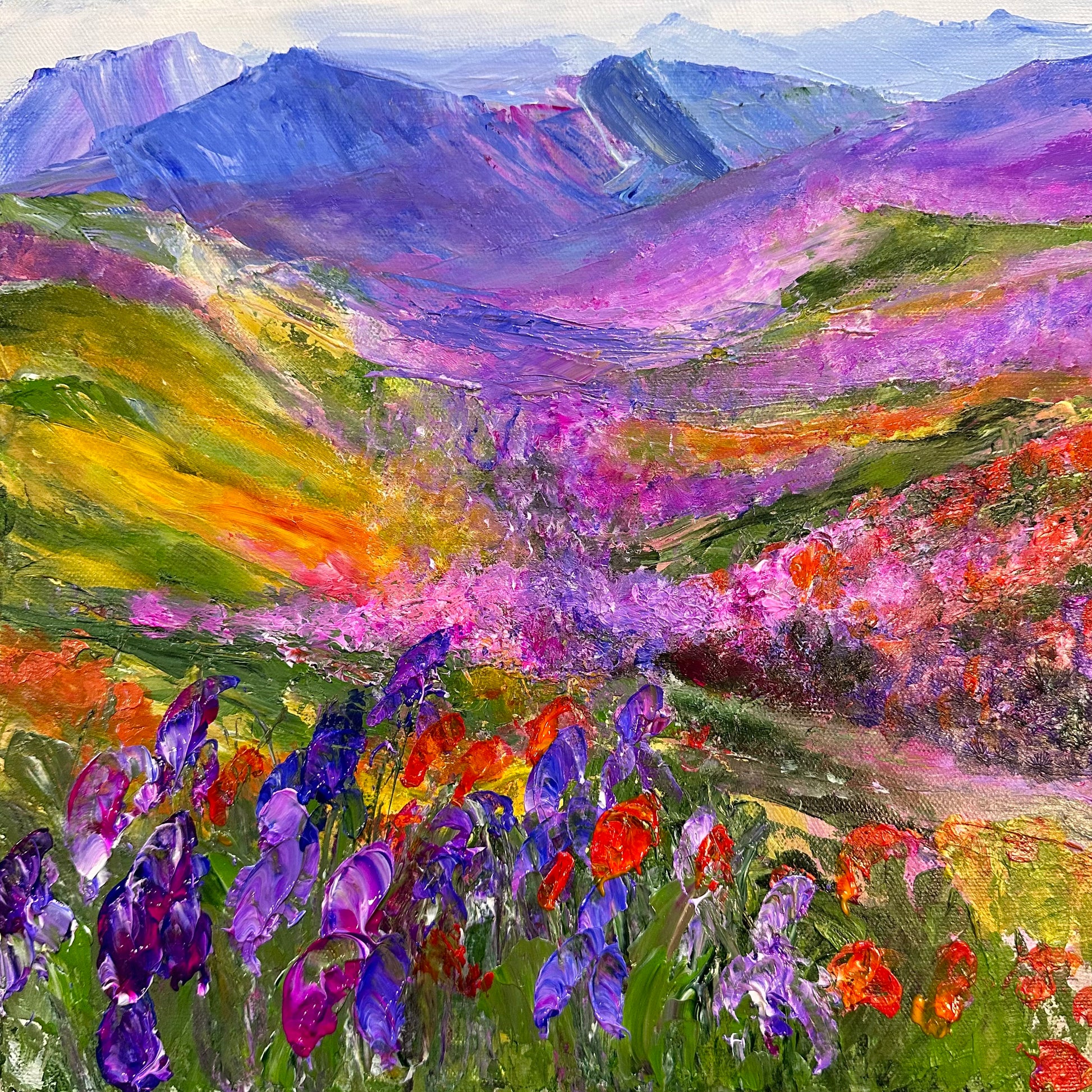 Abstract impressionist acrylic painting of a purple mountain range with wild flowers.
