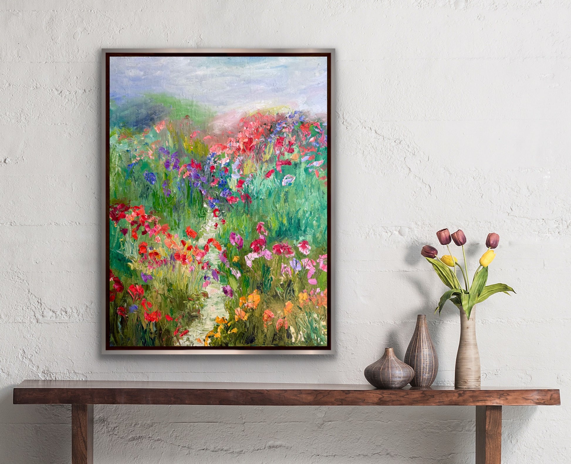 A Stroll in a Flower Field painting styled on a neutral wall with tulips and ceramic vases.