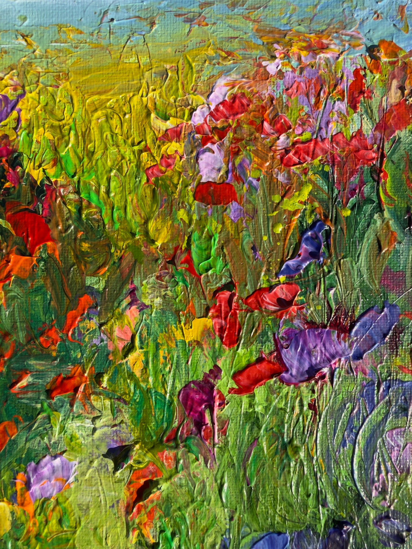 Detail of A Walk in a Flower Field showing textured brushstrokes and vibrant red, purple, and yellow wildflowers
