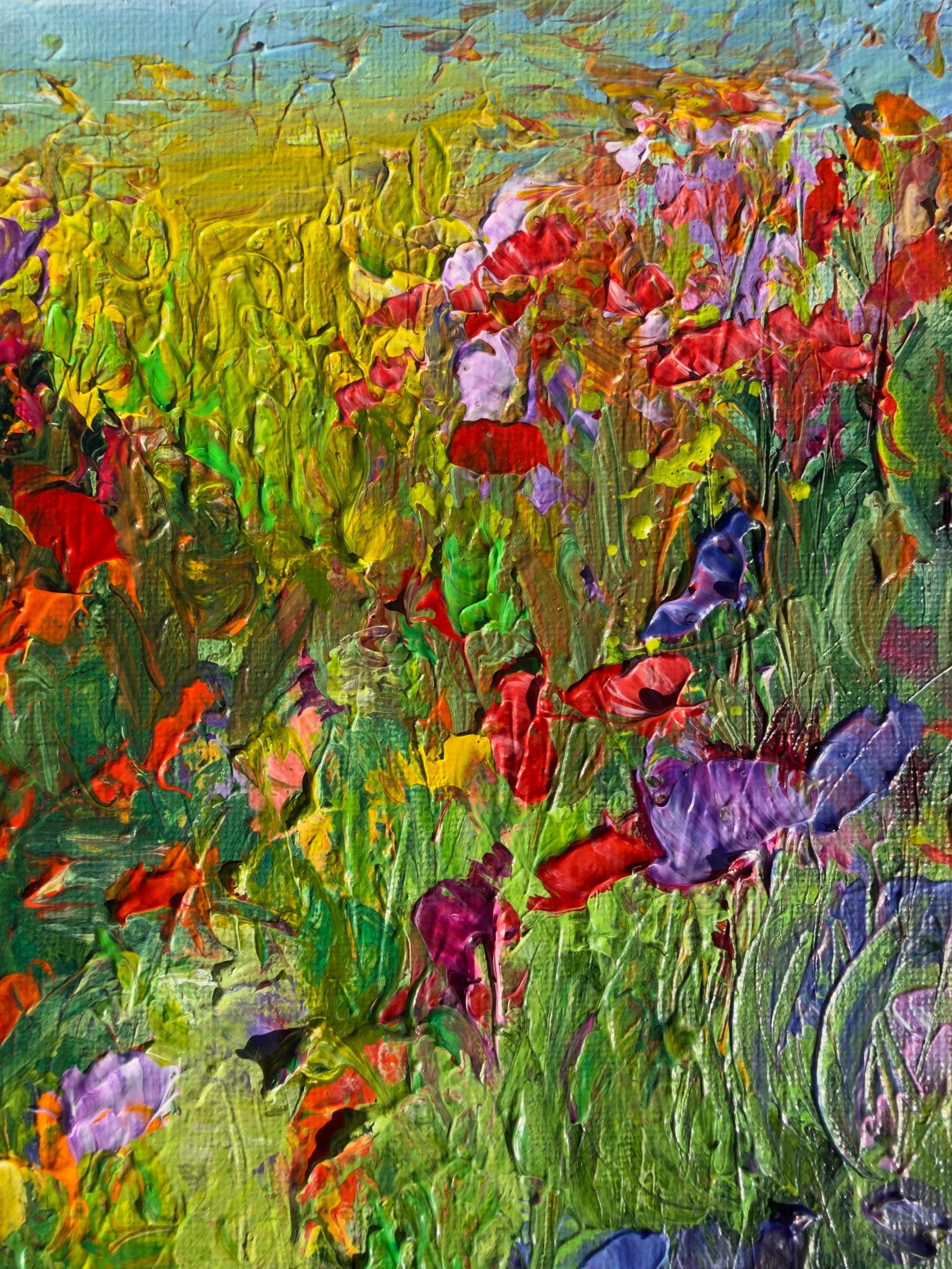 Detail of A Walk in a Flower Field showing textured brushstrokes and vibrant red, purple, and yellow wildflowers