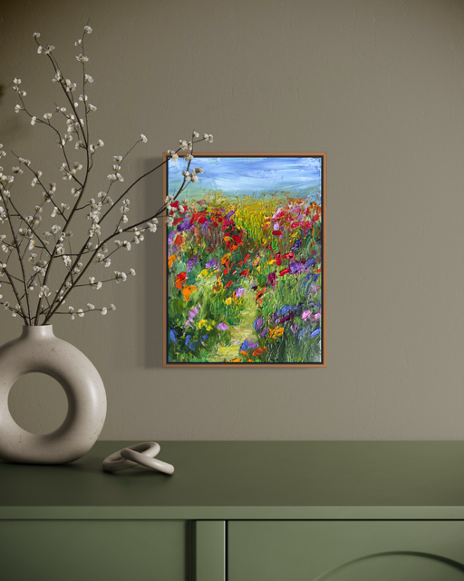 A Walk in a Flower Field painting displayed in a natural, earthy interior with a ceramic vase and green console.