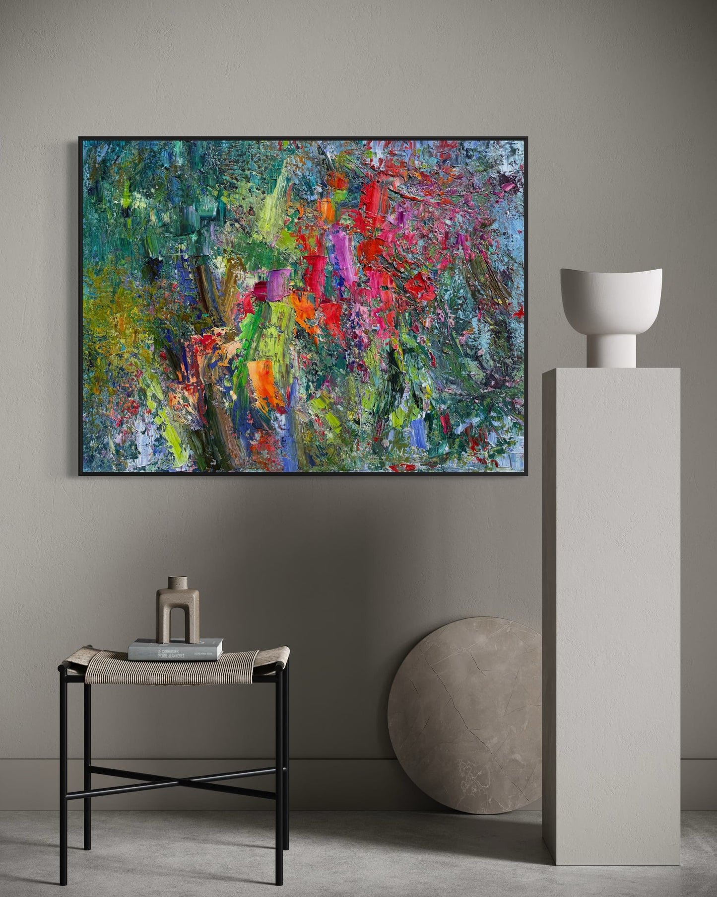 Abstract flower field oil painting hung in a dark contemporary niche above a marble pedestal with sculptural objects