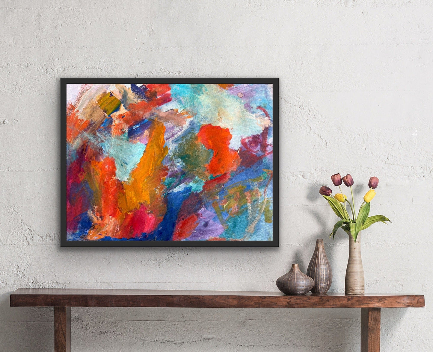 Framed abstract watercolor ‘At Sea’ by MV Checa hanging above a console with tulip arrangement.