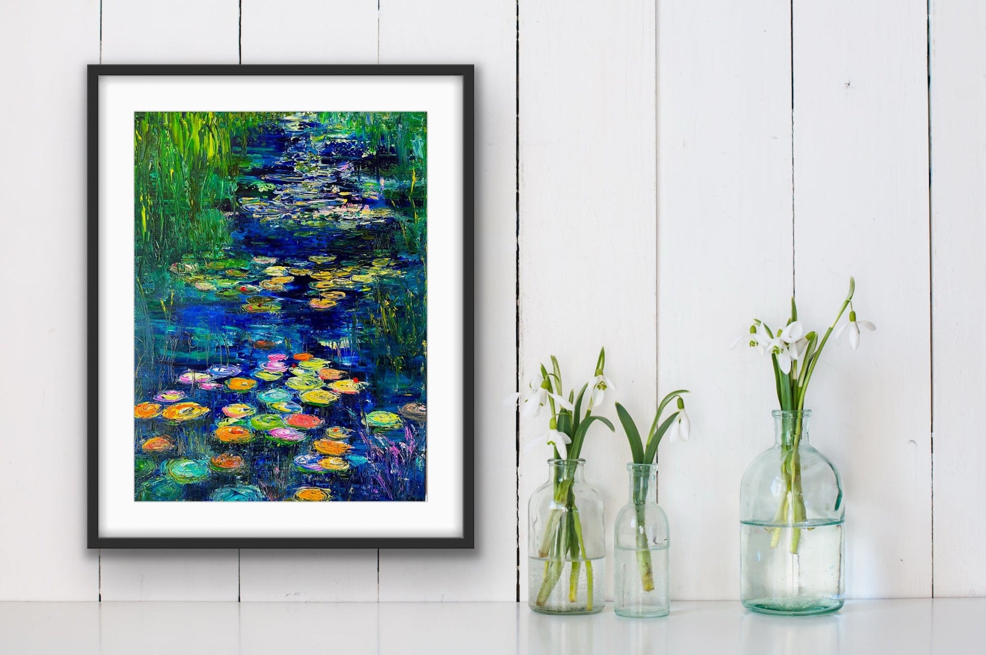 Framed Blue Lily River fine art print by Maria-Victoria Checa styled in a bright modern interior.