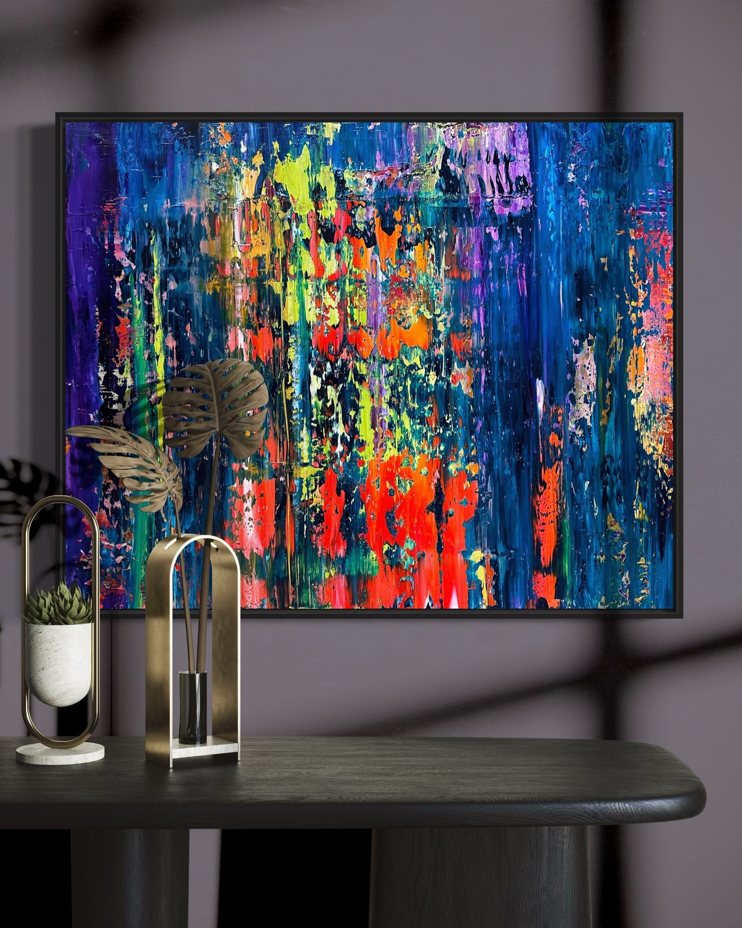 Abstract painting ‘Cognac’ by Maria-Victoria Checa displayed above a modern dark console table with gold decor and soft shadows.