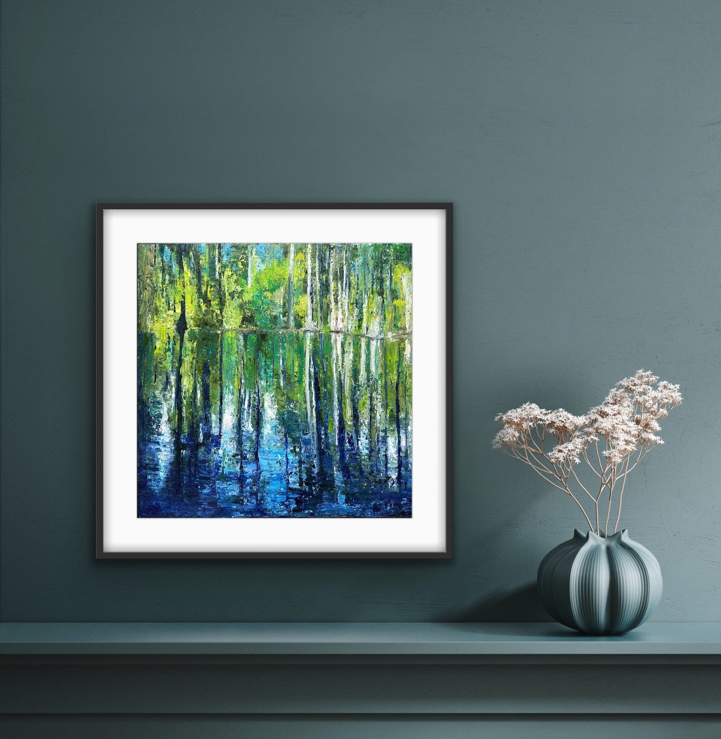 Cypress Gardens Reflection framed paper print by Maria-Victoria Checa in a black frame with white mat, displayed on a deep teal wall in a moody modern interior
