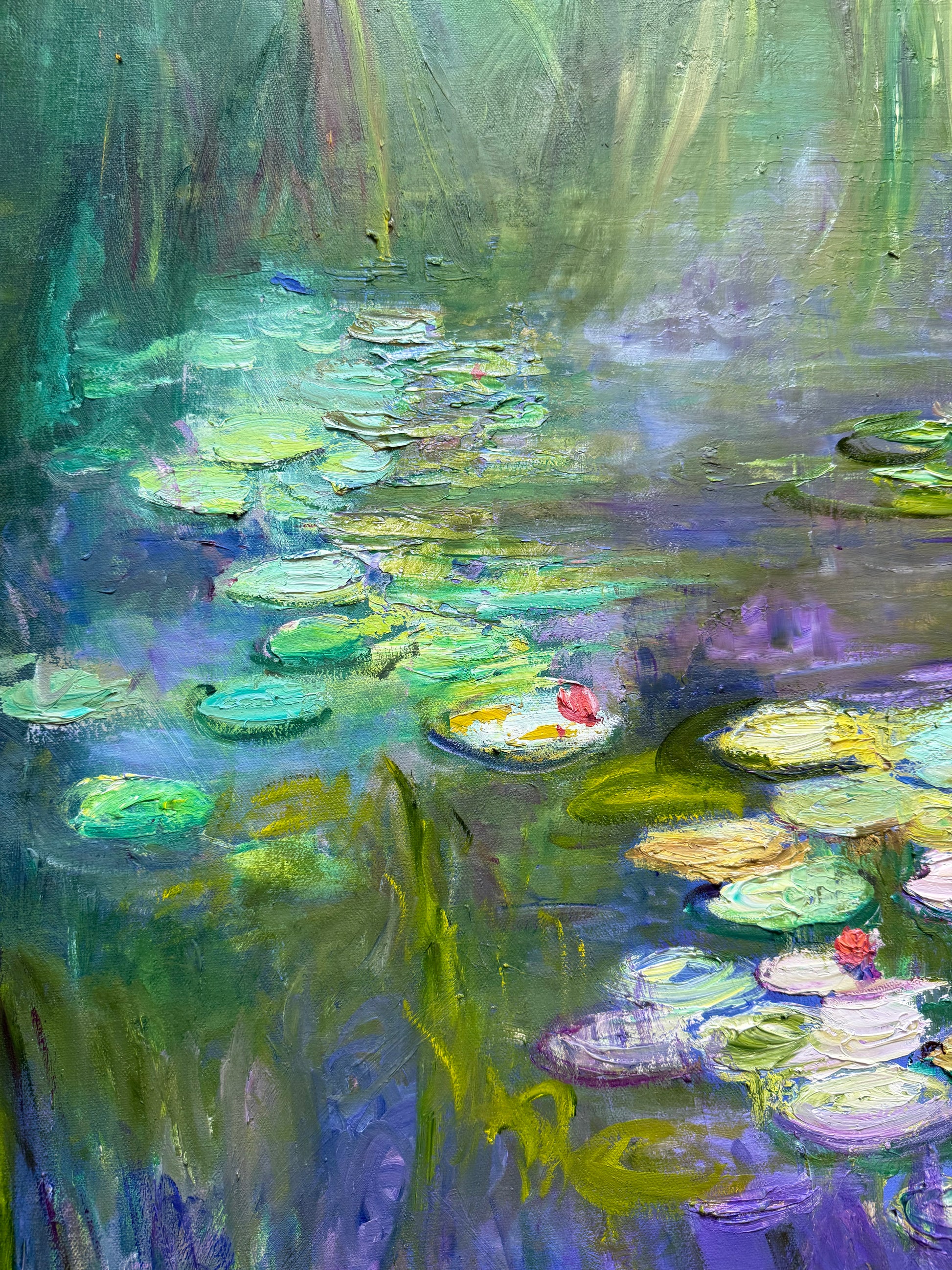 Oil painting of water lilies with a focus on green and blue tones.