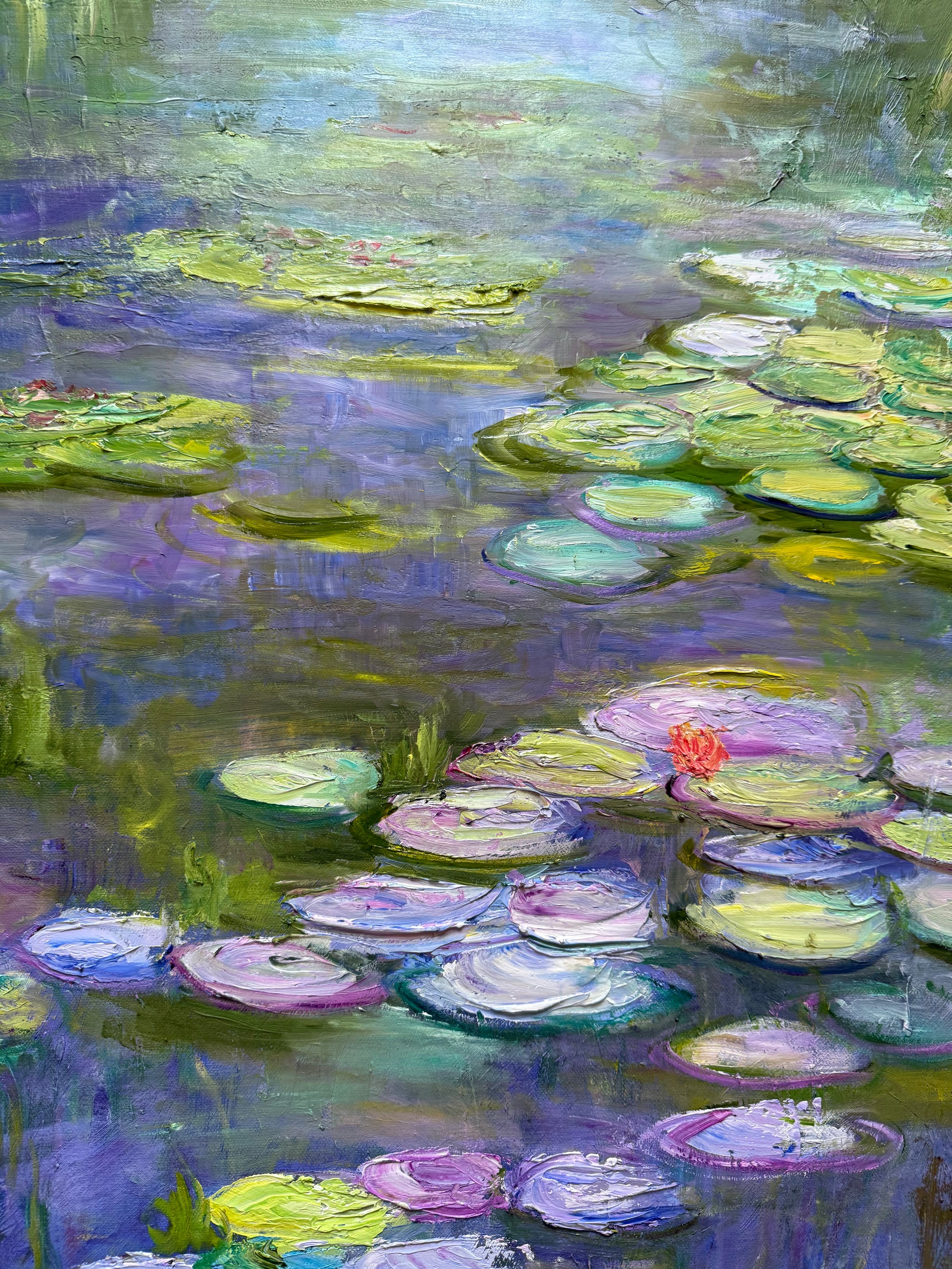Painting of water lilies with a focus on green and purple hues.