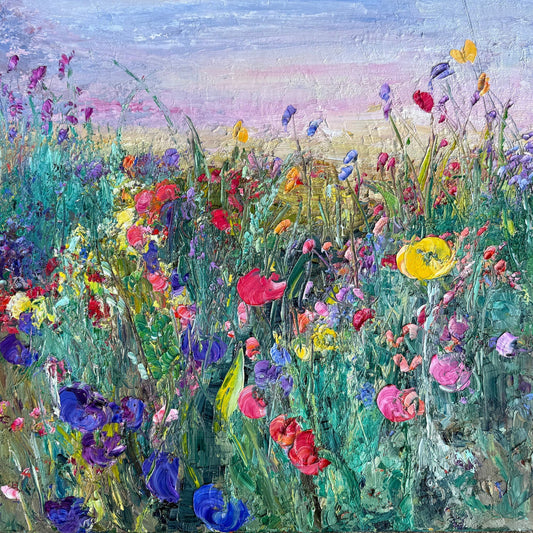 Flower Field at Dusk impressionist painting by Maria-Victoria Checa featuring a lush palette knife wildflower meadow in purple, red, pink, yellow, and blue blooms against a soft lavender and pink dusk sky.