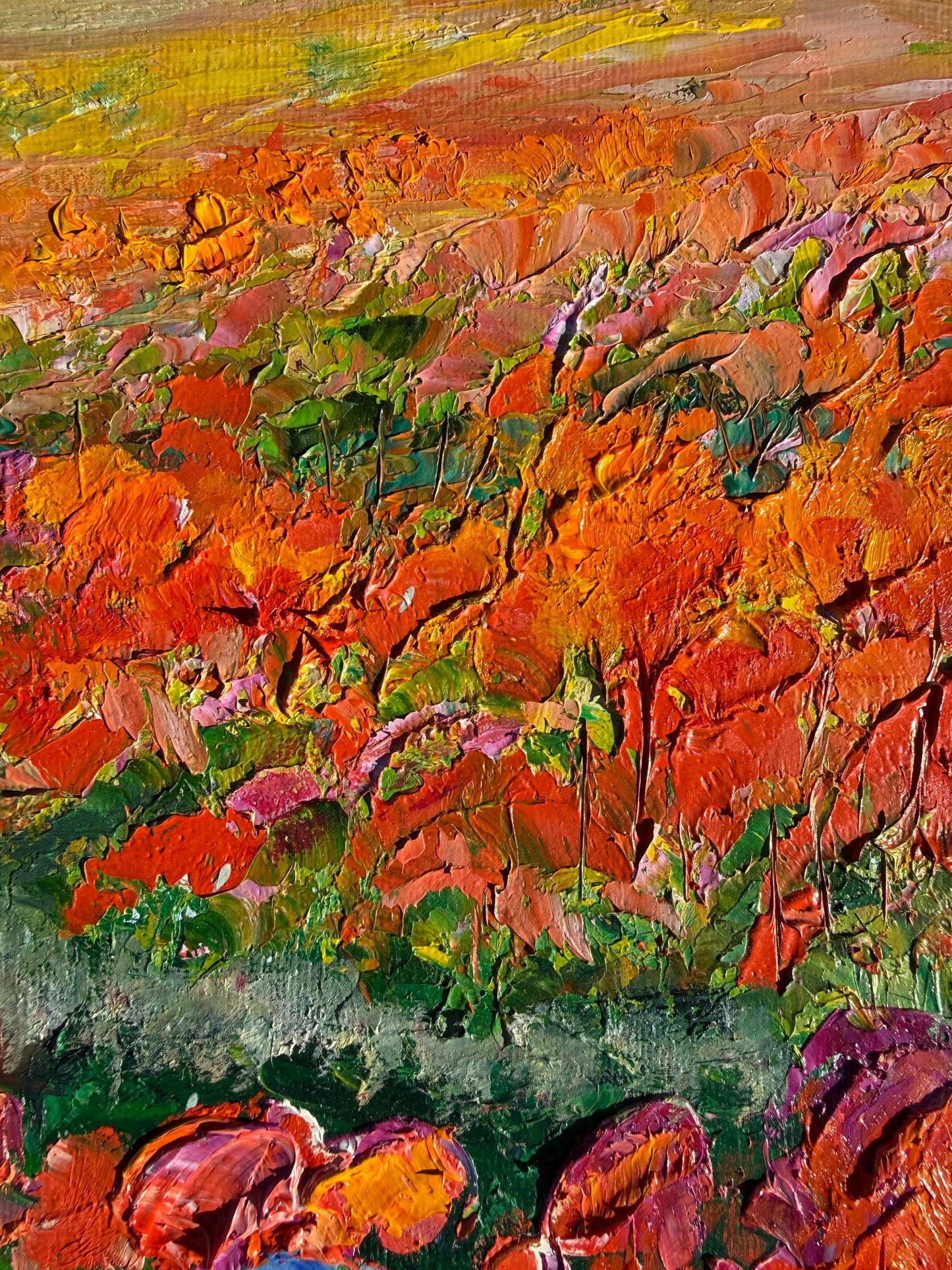 Close-up of bright orange, red, and purple flower textures in the painting ‘Flower Rows’ by Maria-Victoria Checa