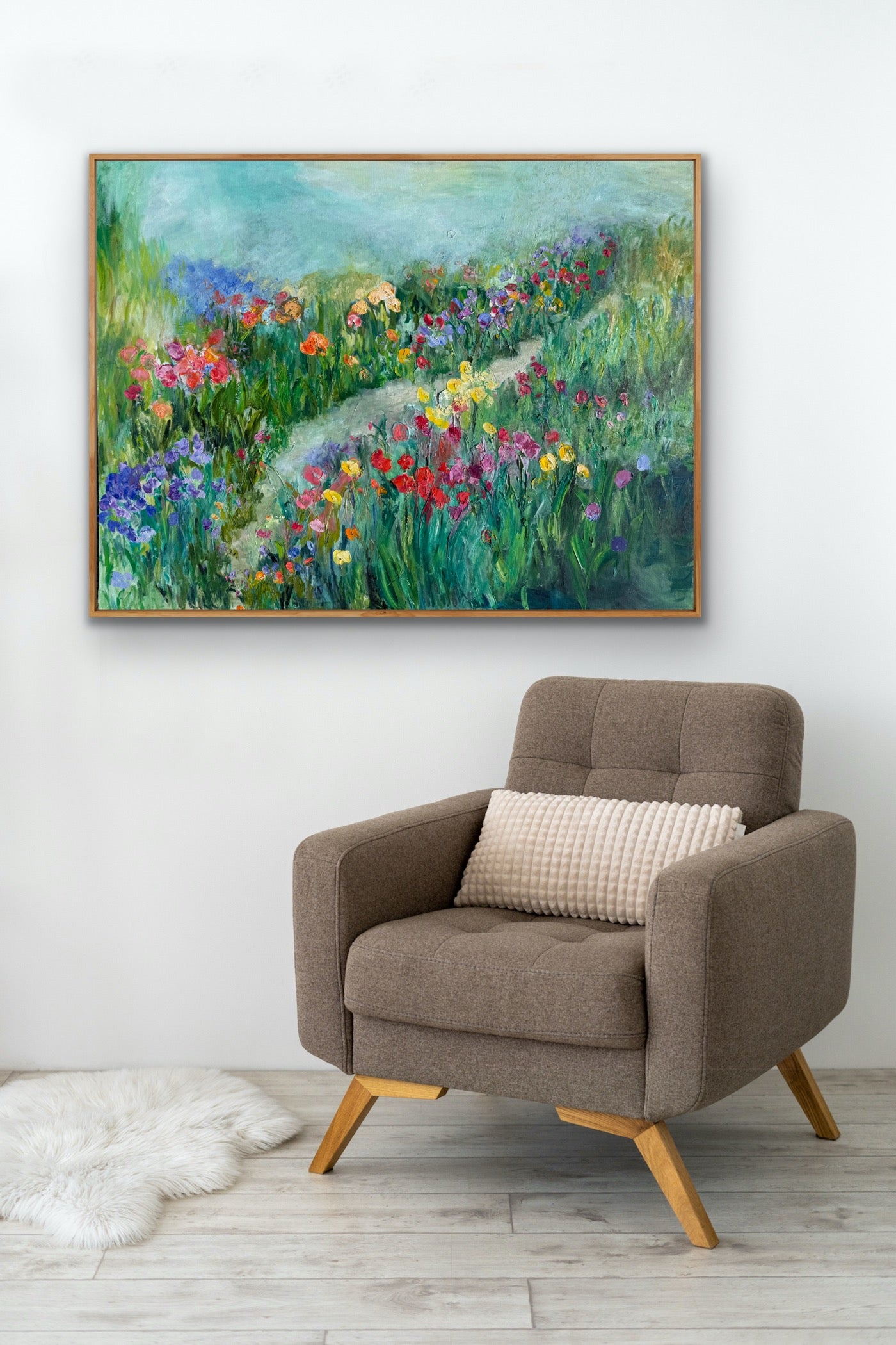Happy Place painting styled next to a modern beige armchair in an elegant living-room.