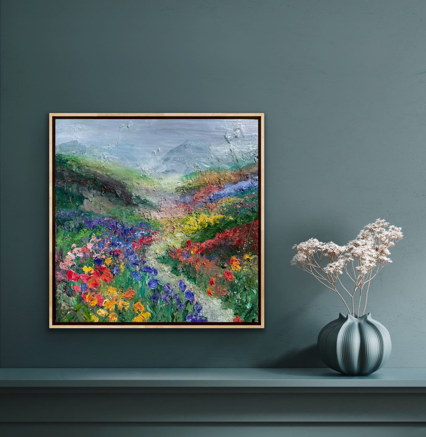 Happy Valley impressionist landscape painting by Maria-Victoria Checa in a natural wood float frame displayed on a deep teal wall above a console table in a moody modern interior