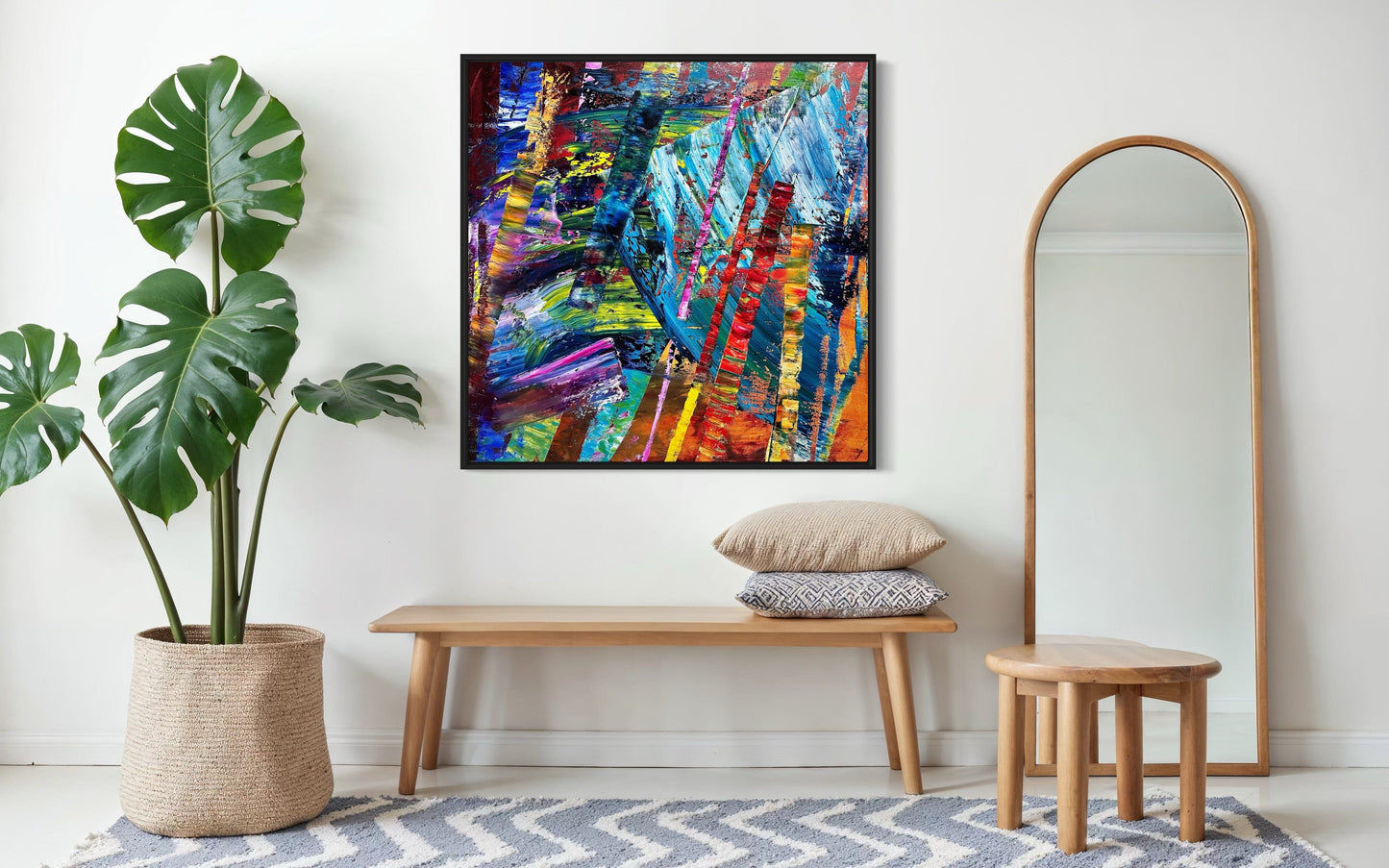 ‘It’s Wild!’ abstract painting styled in a bright entryway above a bench with a floor mirror.