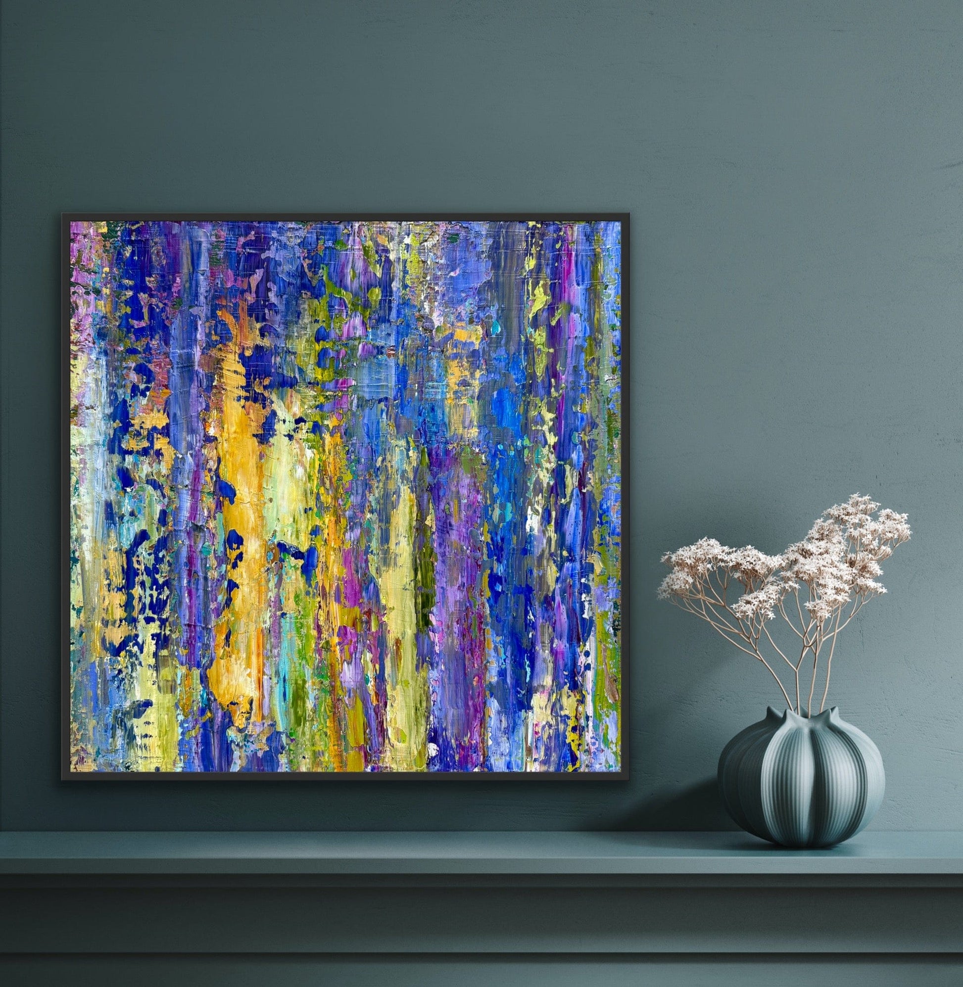 Lavender abstract artwork by Washington DC contemporary artist Maria-Victoria Checa displayed on a teal wall beside a sculptural ceramic vase, featuring expressive blue, lavender, and chartreuse tones.