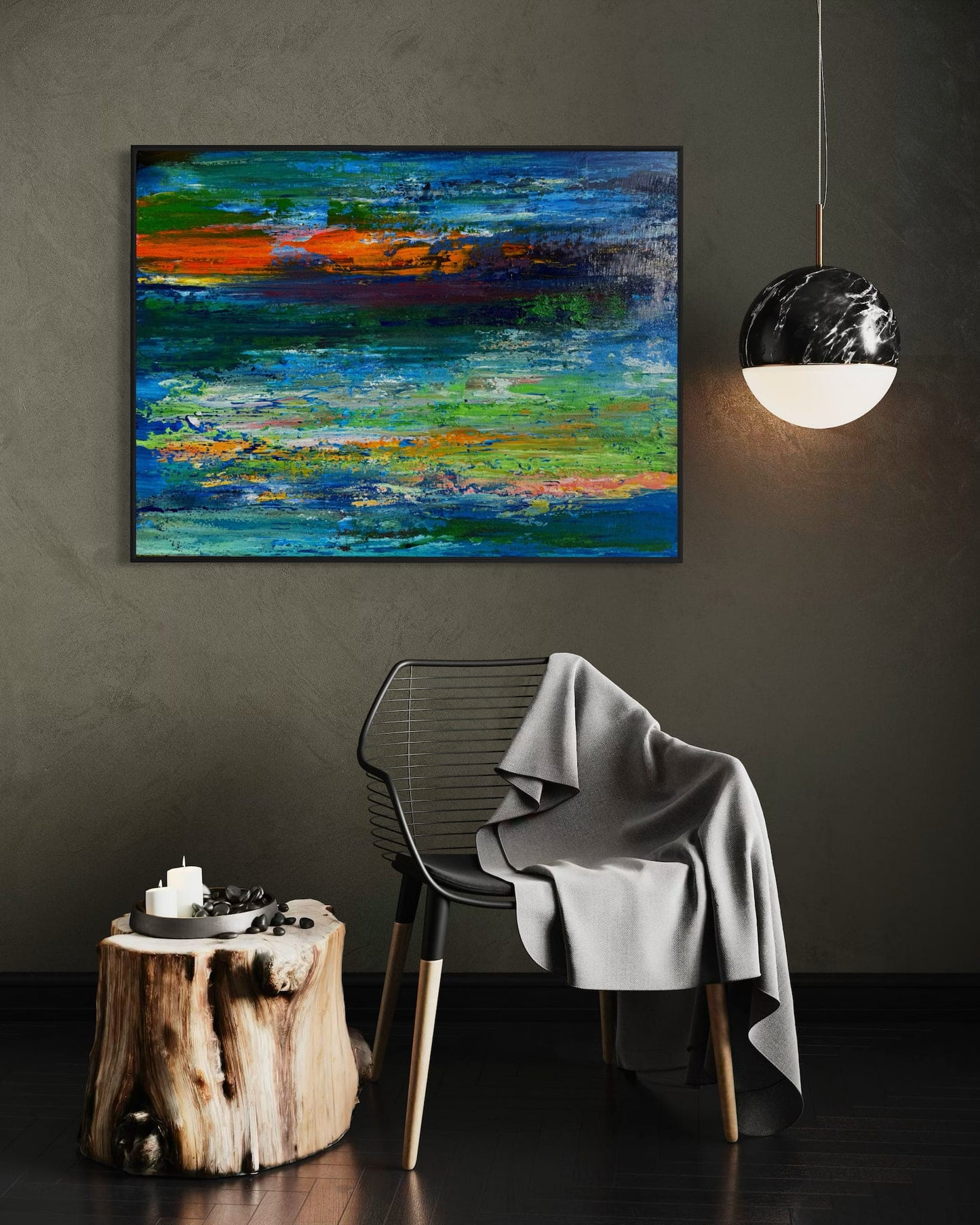 ON EDGE! abstract painting hung horizontally on a dark wall above a wire chair and wood stump side table