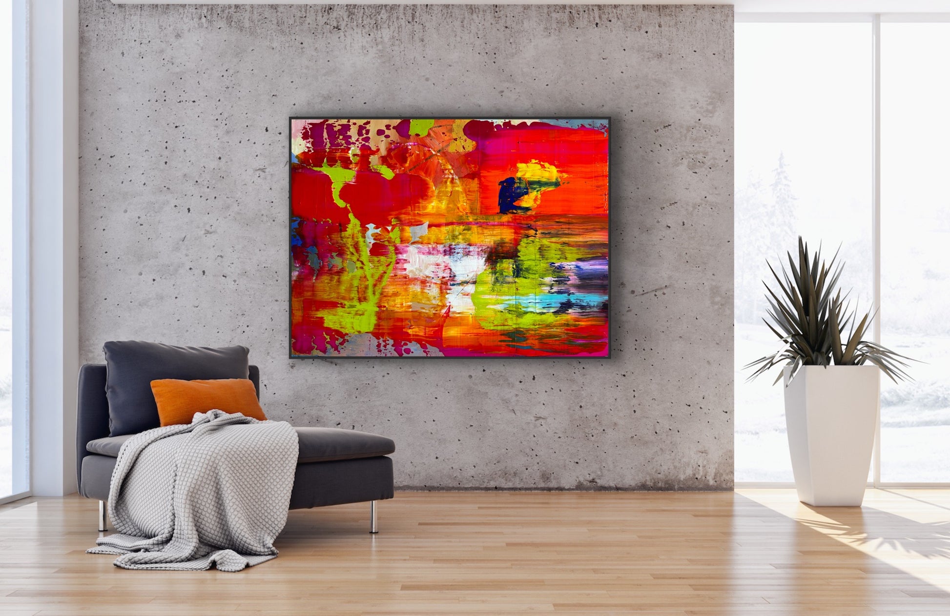 On Fire! colorful abstract painting displayed on a concrete loft wall beside a modern lounge chair and potted plant.
