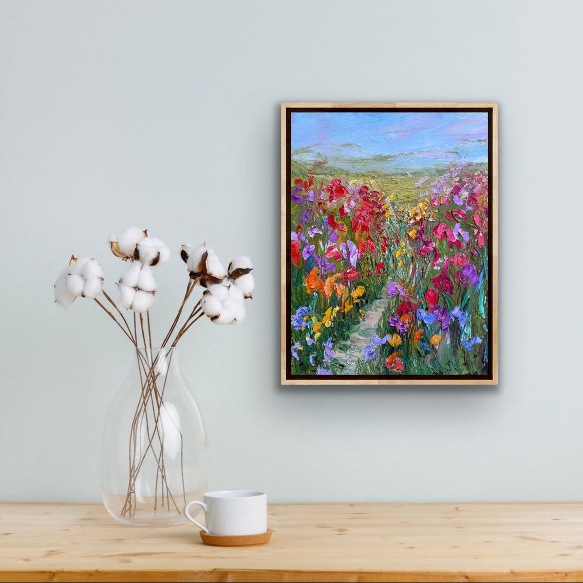 Original impressionist artwork “Path Through Flower Field” by Maria-Victoria Checa shown in a minimalist interior with neutral decor.