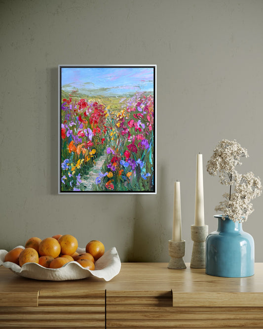 Impressionist landscape painting “Path Through Flower Field” by Maria-Victoria Checa displayed above a wooden console table in a modern interior.