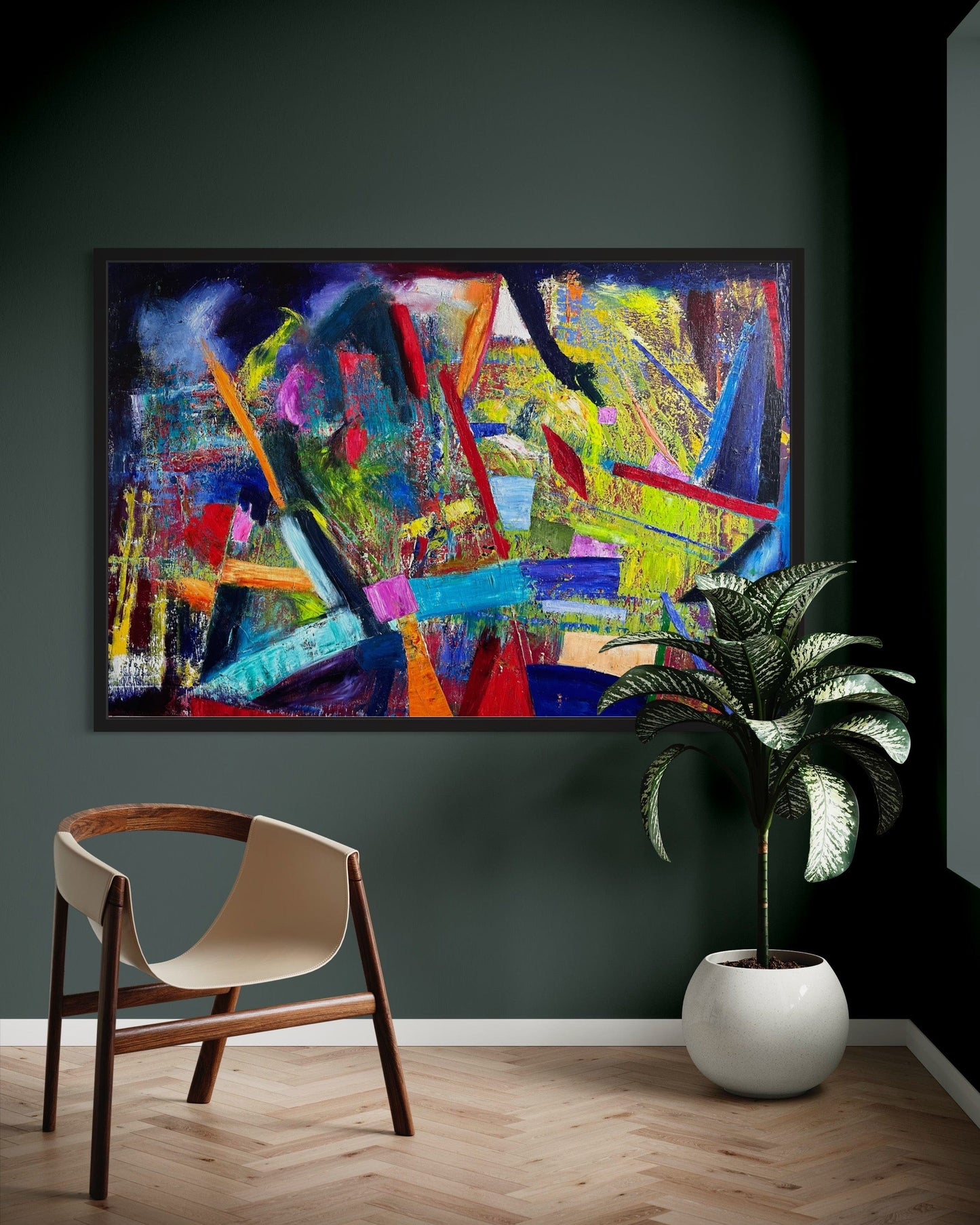 Play Time! colorful abstract oil painting displayed on a dark green wall with a modern chair and indoor plant.