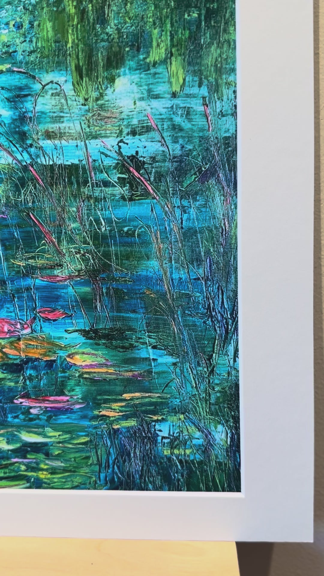 Video showcasing the “Mirror of Time” fine art print by artist Maria-Victoria Checa, featuring a vibrant impressionist water reflection with colorful lily pads and teal, green, and blue tones.