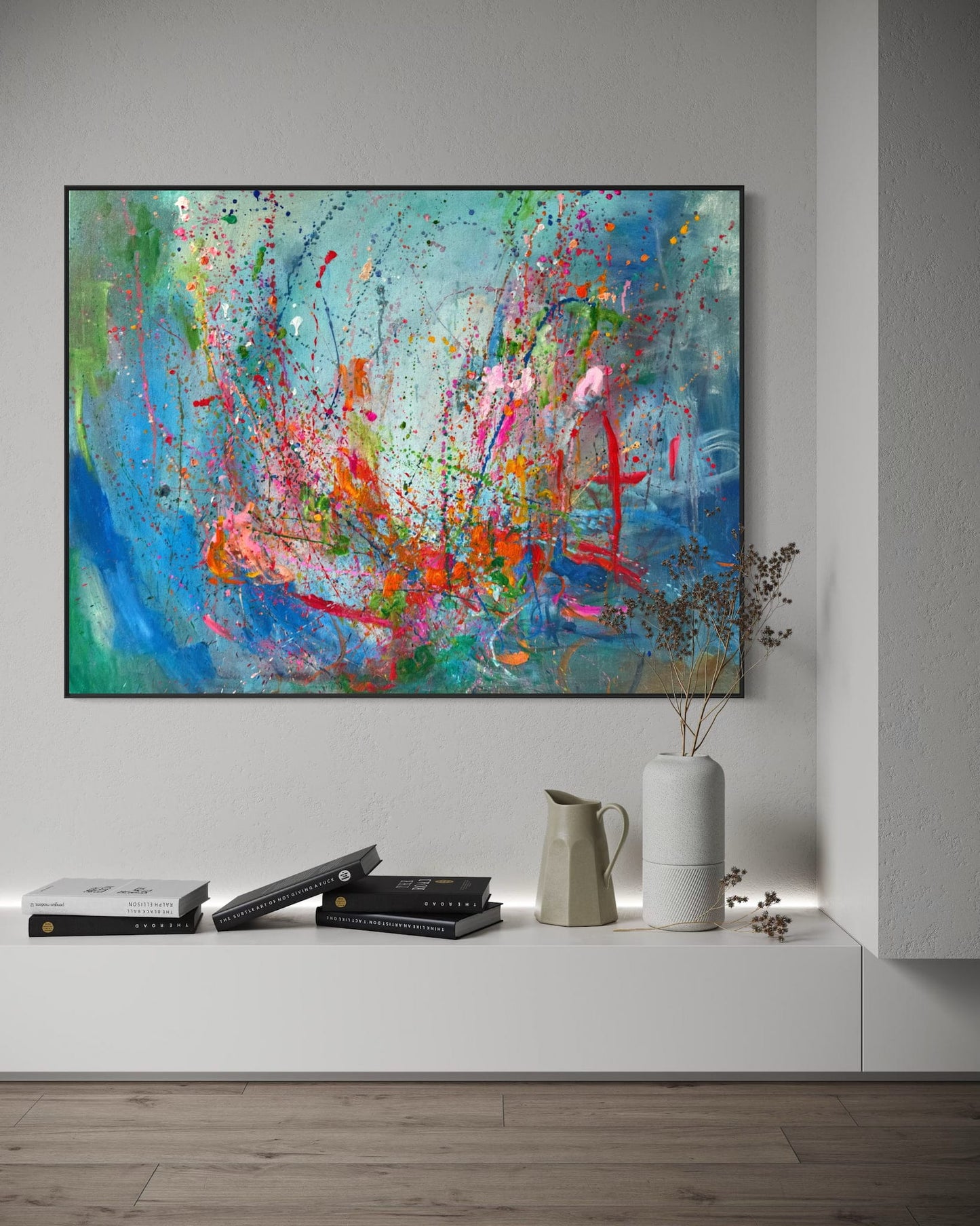 Roller Coaster abstract painting displayed above console shelf with books and vases