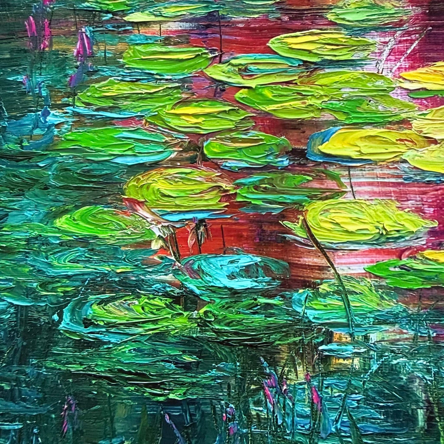 Close-up detail of Sunset Lilies by Maria-Victoria Checa showing thick palette knife texture on green and yellow lily pads floating over deep teal water with magenta and orange sunset reflections