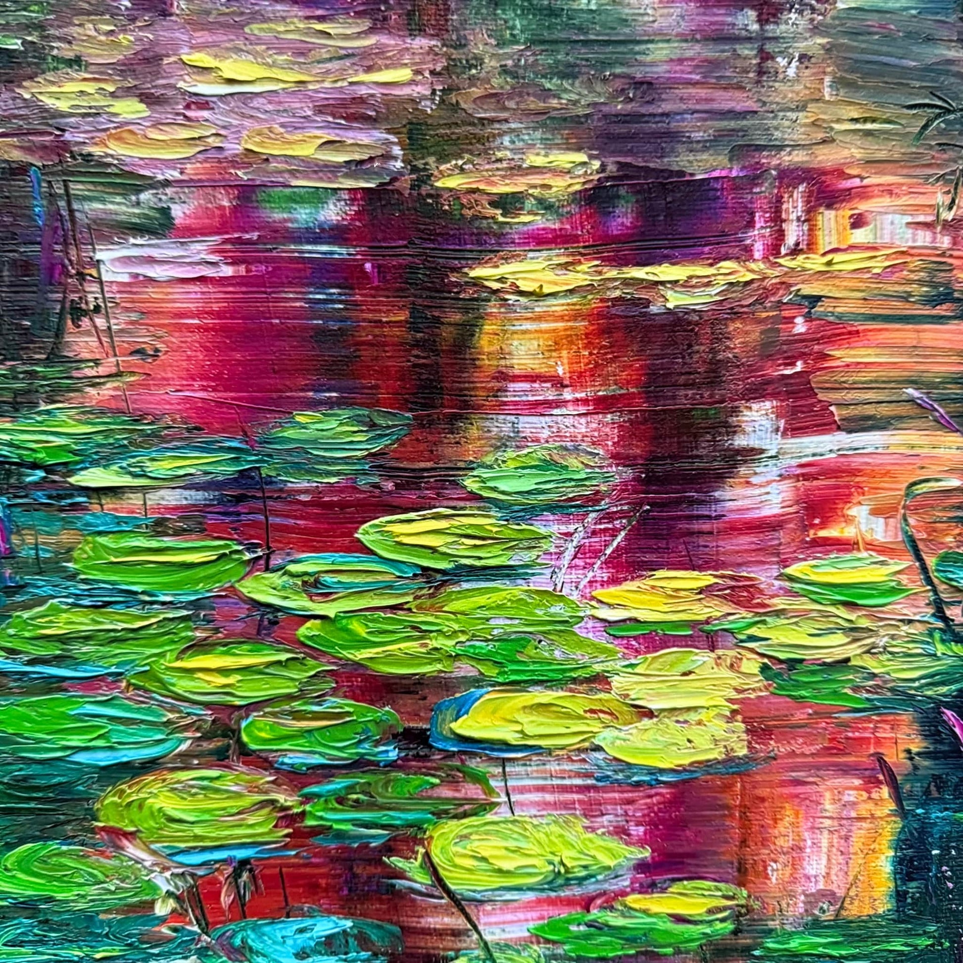 Detail of Sunset Lilies by Maria-Victoria Checa showing textured palette knife lily pads in chartreuse and green against bold crimson and magenta sunset reflections on a deep teal pond.
