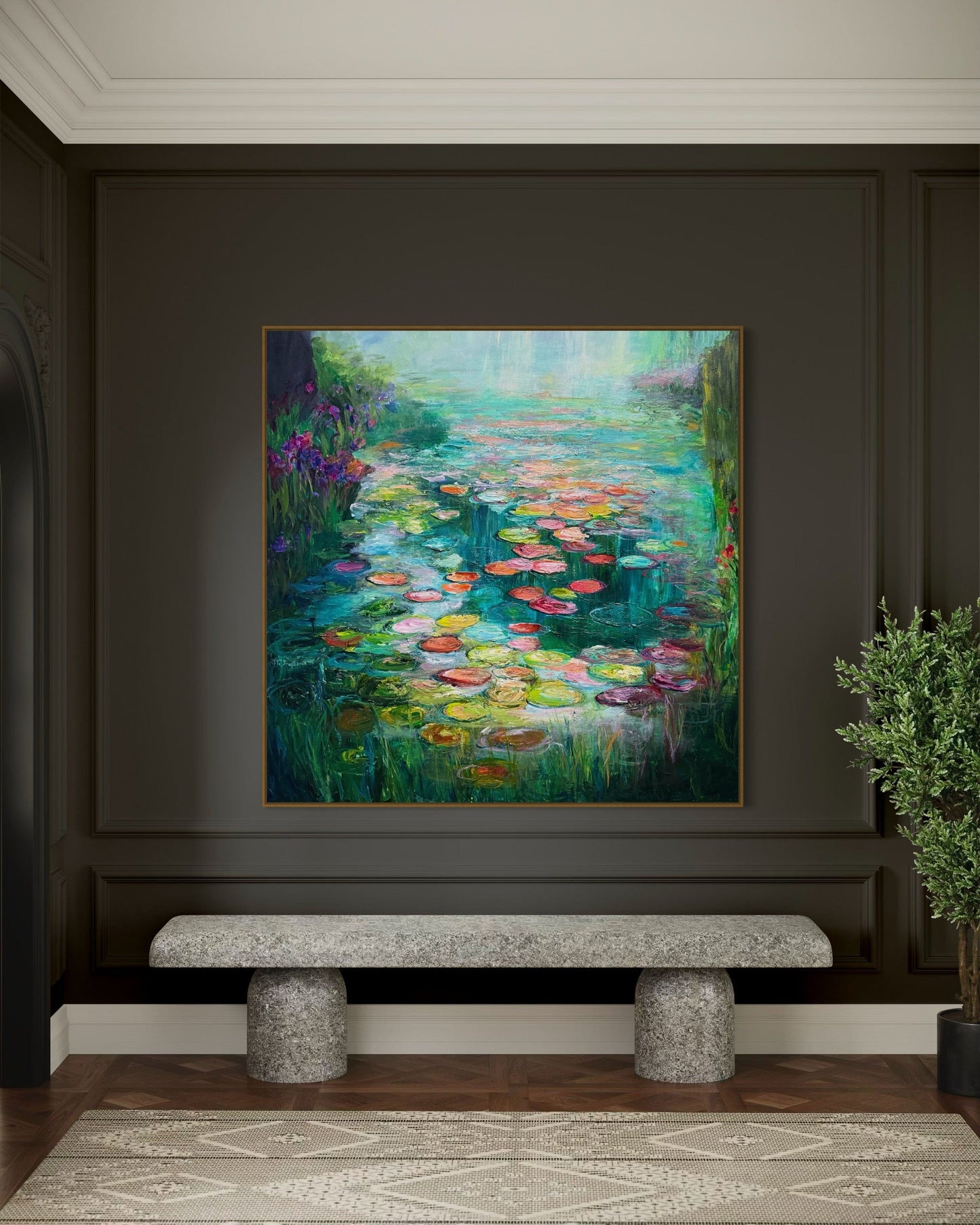 “Waterlily Garden” impressionist water lily painting by Maria-Victoria Checa displayed in a modern dark-walled interior with a stone bench and greenery. Vibrant teal water, colorful lily pads, and textured brushstrokes create a serene, Monet-inspired atmosphere.
