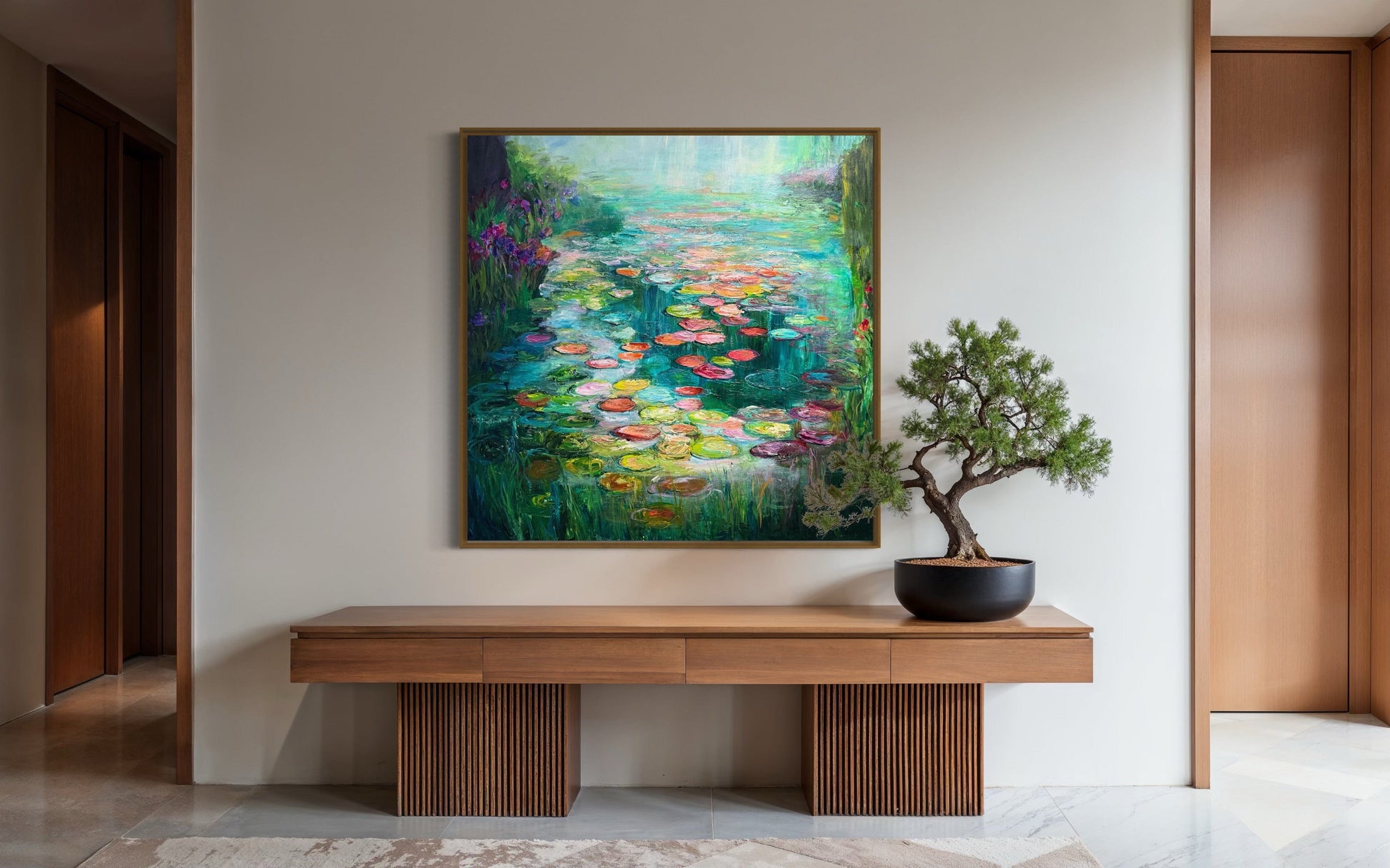 “Waterlily Garden by Maria-Victoria Checa displayed in a modern entryway above a sleek wooden console table, showing colorful waterlilies and glowing reflections.”