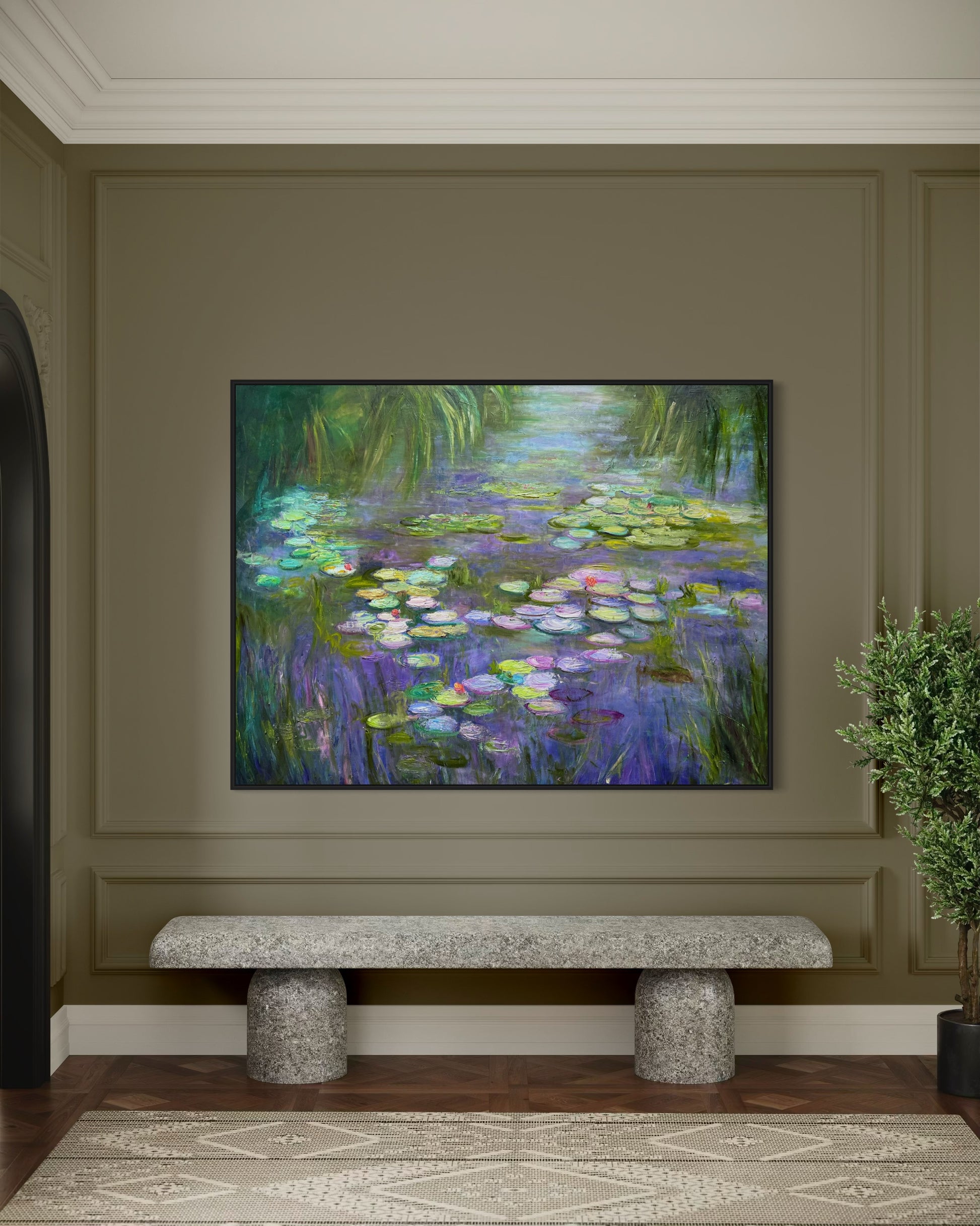 Framed painting of water lilies on a wall above a stone bench.