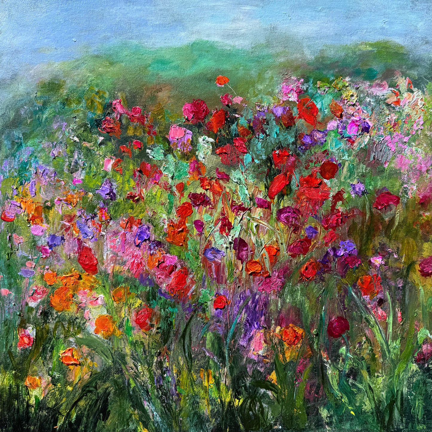 Impressionist painting of a vibrant meadow filled with wildflowers and layered texture by Maria-Victoria Checa
