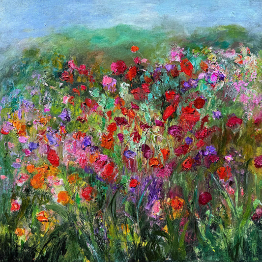 Wild Flowers impressionist painting by Maria-Victoria Checa featuring a dense palette knife wildflower meadow in red, orange, purple, and pink blooms against a lush green treeline and soft blue sky.