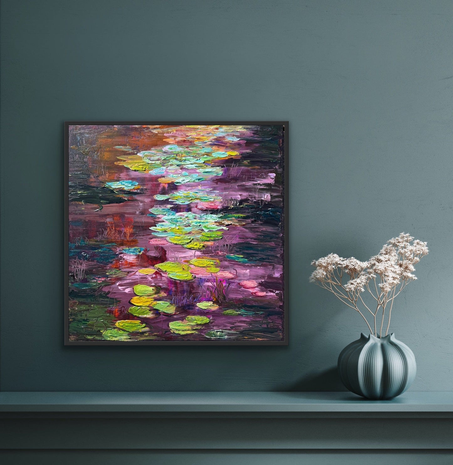 Framed impressionist landscape painting by Maria-Victoria Checa displayed in a contemporary interior with a vase of flowers.