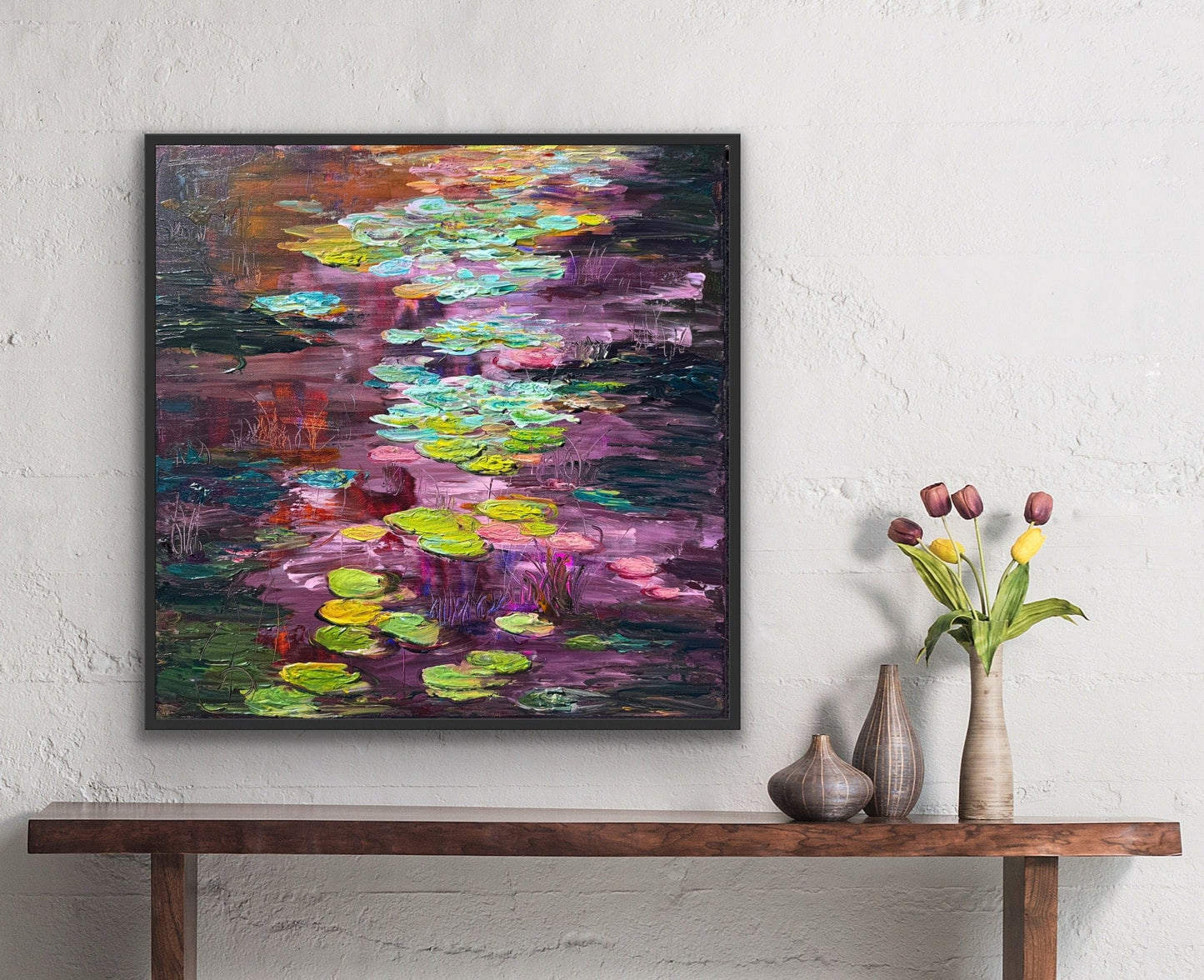 Impressionist landscape painting by Maria-Victoria Checa displayed over a side table with tulips.