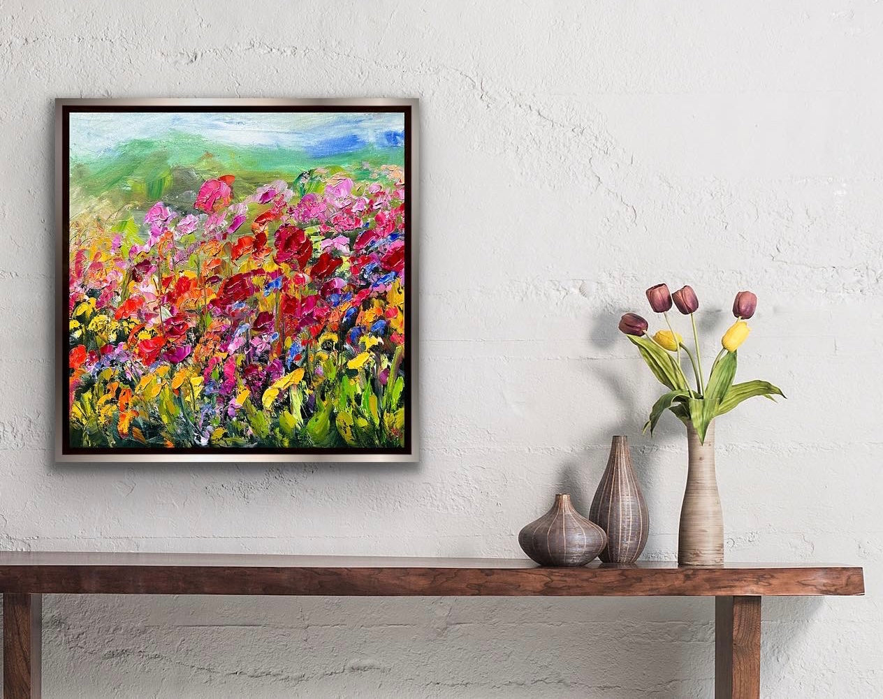abstract impressionist oil painting of a flower field of all colors on a wall next to tulips.