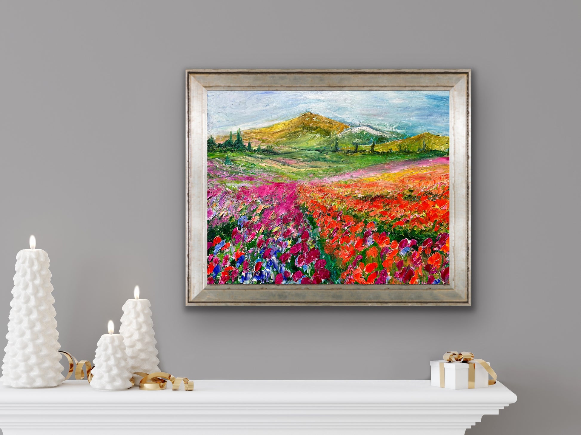 abstract impressionist oil painting of rows of orange and purple flowers with mountain hanging in room with white shelf